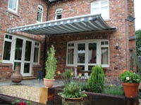 Domestic awnings fitted by Rolux UK over patio.