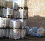 Stacks of 1,000 litre plastic containers which contained many different hazardous liquids.