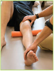 Physiotherapist giving treatment for a knee injury.