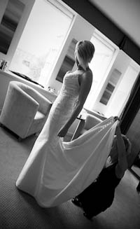 putting the finishing touches to the wedding dress, picture in black and white.
