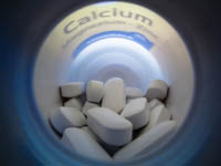 Image of a bottle of calcium pills as part of a fitness regime.
