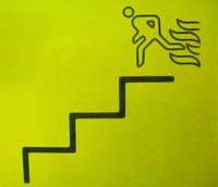 Fire Exit sign showing figure directed down stairs