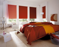 Colour co-ordinated roller blinds fitted to bedroom windows.